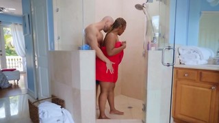 Bald man relaxes in the shower together with curvy dark-hued diva